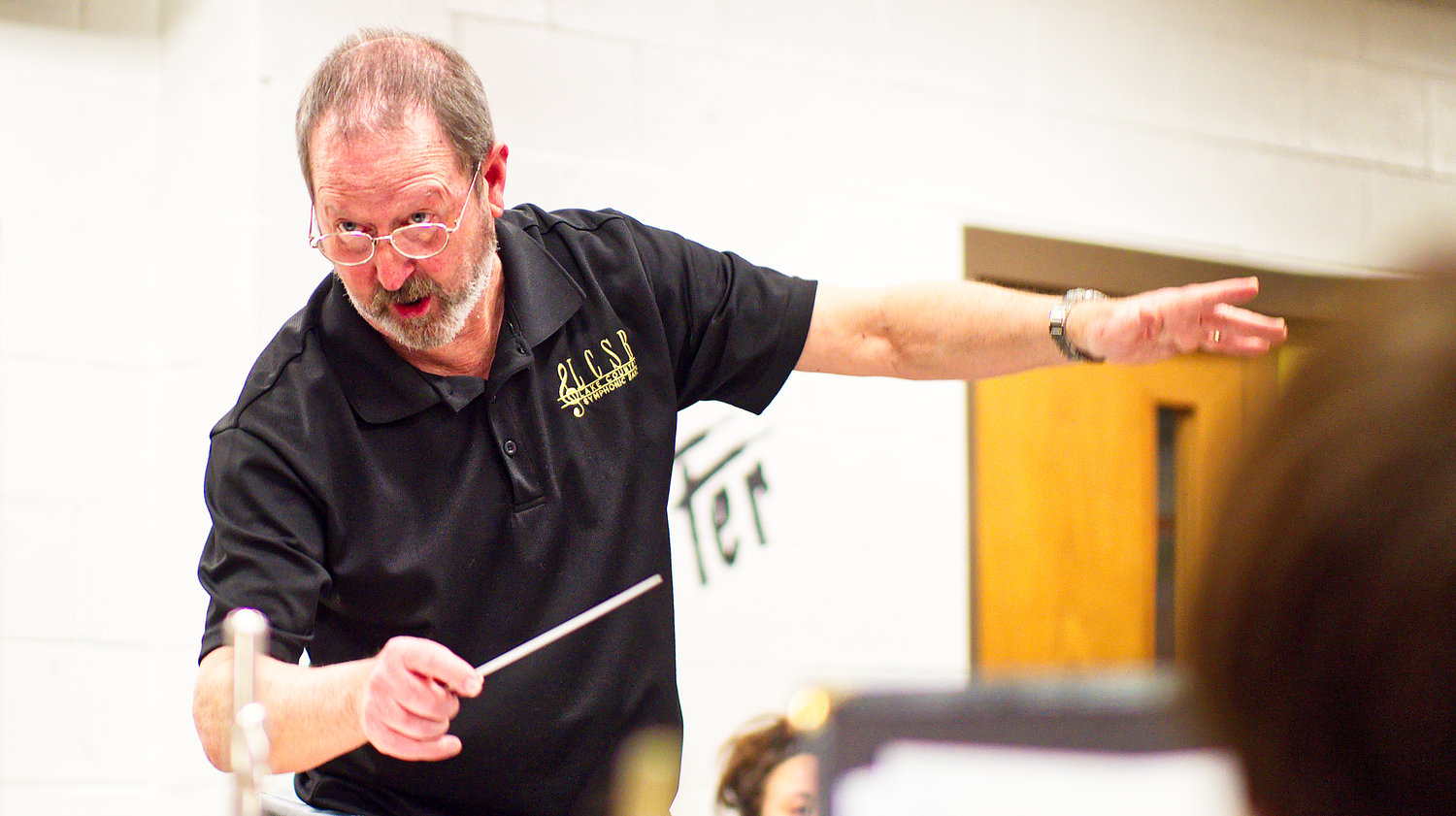Mike Holbrook conducts rehearsal for the Lake Country Symphonic Band, preparing for his final concerts with the band March 27 and 29.